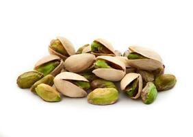 Pistachio nuts. Many pistachios isolated on white. photo