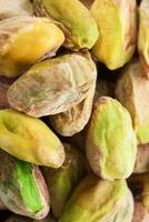 Pistachio nuts. Many pistachios as a background, texture top view photo