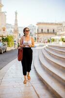 Female tourist with city map by the Saint Oronzo statue in Ostuni, Italy photo