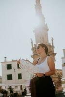 Female tourist with city map by the Saint Oronzo statue in Ostuni, Italy photo