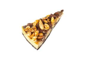 Slice of cheesecake caramel with peanuts and cookies top view on white background isolated photo