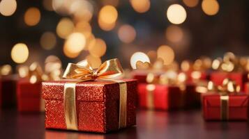 Christmas red gift boxes with gold bow on defocused holiday background with copy space photo