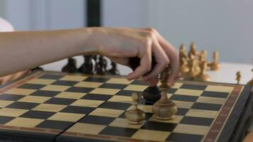 two person are playing chess on a board video