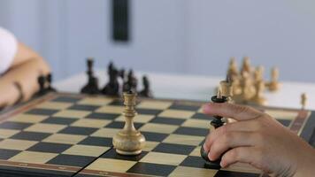 two person are playing chess on a board video