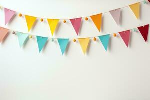 Colorful holiday flags in the form of a garland on the wall. The garland hangs in two rows. Congratulatory background with place for text. Holiday concept photo