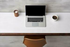 Table for working at a computer. Workplace at home, light table with computer, mouse and cup. Top view photo