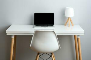 Table for working at a computer. Workplace at home.Desk with laptop, desk lamp and chair. Side view photo