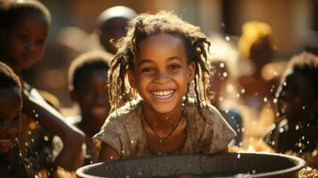 Portrait of a smiling african girl bathing in water from a bowl at Himba village near Etosha National Park in Namibia, Africa. photo