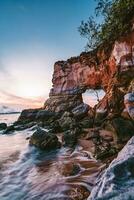 Buffalo Nose Cape, Ao Tha Len, Krabi Province, Thailand, rocky cliff with a hole through which you can pass through. It looks like an elephant's trunk. Sunset time is very beautiful. photo