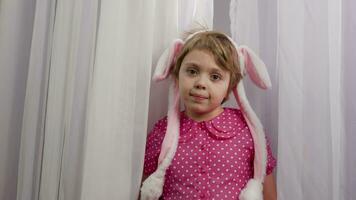 a little girl wearing a pink polka dot dress and bunny ears video