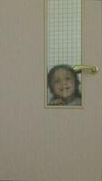 a child is peeking through a door video