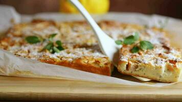 prepared curd semolina pie with quince inside and covered with powdered sugar . video