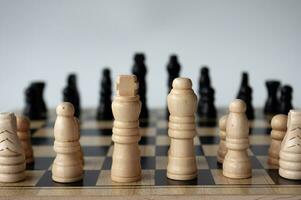 Battle between white and black chess on a chess boar. Strategy and tactics concept photo