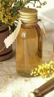 a small vase with yellow flowers on a table video