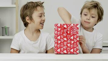 two young boys are opening a gift box video