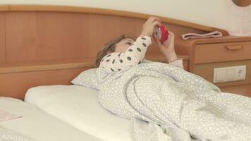 a little girl laying in bed with a alarm clock video