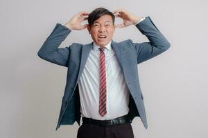 Businessman in a suit showing a stressed expression photo