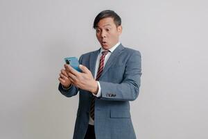 Businessman in a suit uses a mobile phone photo