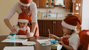 a woman and child in santa hats at a table video