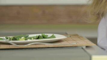 a plate with green beans and broccoli on it video