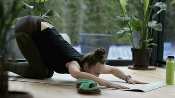 a woman is doing yoga on a mat video