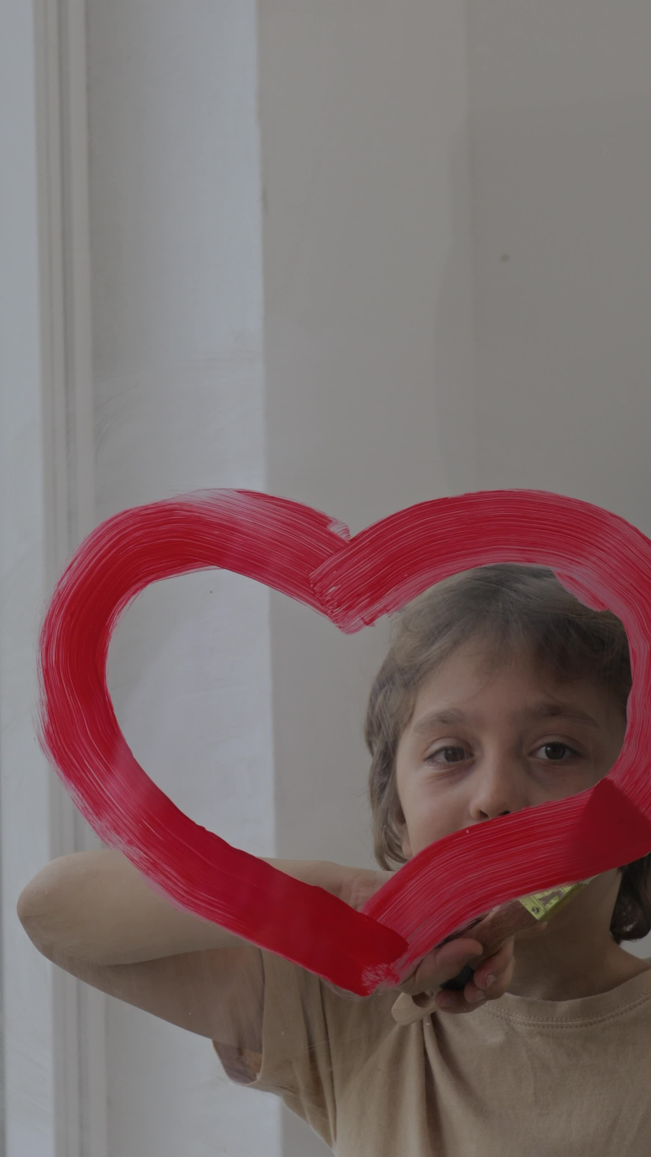 a child drawing a heart shaped on a glass 32206367 Stock Video at Vecteezy
