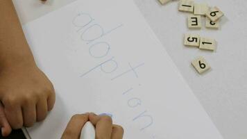 a child writing on a piece of paper with a marker video