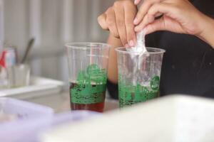 Hand of Indonesian street vendor prepares a glass of iced photo