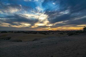 colorful sunset on the Spanish island of Gran Canaria in the Maspalomas dunes photo