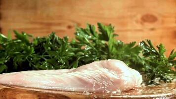 Chicken fillet falling on a cutting board. Filmed on a highspeed camera at 1000 fps. High quality FullHD footage video