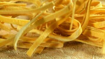 Pasta falls on the table with flour. Filmed on a highspeed camera at 1000 fps. High quality FullHD footage video