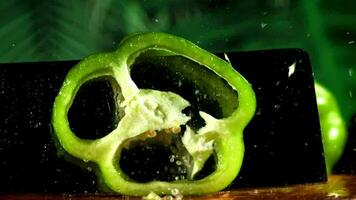 Slicing sweet peppers on a cutting board. Filmed on a highspeed camera at 1000 fps. High quality FullHD footage video