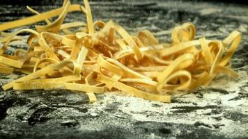 Pasta falls on the table with flour. Filmed on a highspeed camera at 1000 fps. High quality FullHD footage video