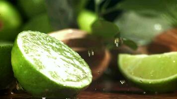 Drops of water fall on a cut lime. Filmed on a highspeed camera at 1000 fps. High quality FullHD footage video