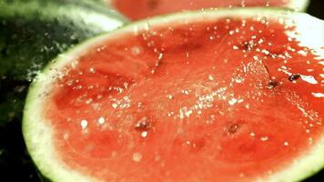 Drops of water fall on the cut of a watermelon. Filmed on a highspeed camera at 1000 fps. High quality FullHD footage video