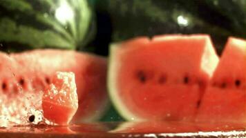 Watermelon pulp falls on a wet cutting board. Filmed on a highspeed camera at 1000 fps. High quality FullHD footage video