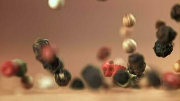 Peppercorn falling on the table. Macro shot. Filmed on a highspeed camera at 1000 fps. High quality FullHD footage video