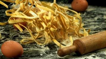 Pasta falls on the table with flour. Filmed on a highspeed camera at 1000 fps. High quality FullHD footage video