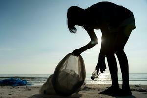 Save water. Volunteer pick up trash garbage at the beach and plastic bottles are difficult decompose prevent harm aquatic life. Earth, Environment, Greening planet, reduce global warming, Save world photo