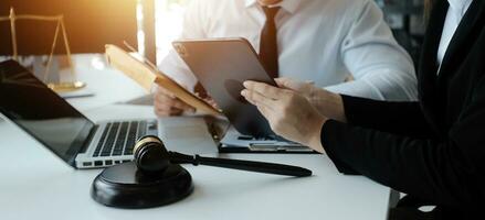 Male lawyer working with contract papers and wooden gavel on tabel in courtroom. justice and law ,attorney, court judge, concept. photo