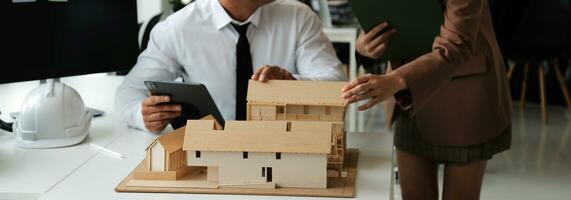 Construction and structure concept of Engineer or architect meeting for project working with partner and engineering tools on model building and blueprint in working site, contract for both companies. photo