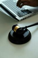 Judge gavel with Justice lawyers having team meeting at law firm in background. Concepts of law. photo