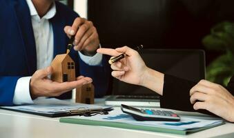 Female woman hands holding home model, small miniature white toy house. Mortgage property insurance dream moving home and real estate concept photo