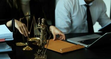 Judge gavel with Justice lawyers having team meeting at law firm in background. Concepts of law. photo