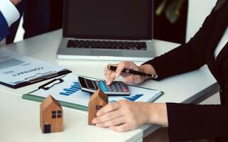 Female woman hands holding home model, small miniature white toy house. Mortgage property insurance dream moving home and real estate concept photo