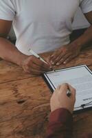 Close up view of job interview in office, focus on resume writing tips, employer reviewing good cv of prepared skilled applicant, recruiter considering application, hr manager making hiring decision photo