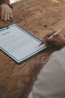 Close up view of job interview in office, focus on resume writing tips, employer reviewing good cv of prepared skilled applicant, recruiter considering application, hr manager making hiring decision photo
