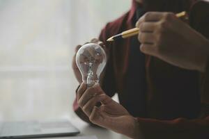 Inspiration. hand hold light bulb for good idea. brainstorming creative idea. photo