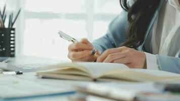 Young asian business woman working on project plan using sticky papers notes on glass wall, people meeting to share idea, Business design planning concepts. video