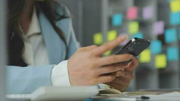 Young asian business woman working on project plan using sticky papers notes on glass wall, people meeting to share idea, Business design planning concepts. video